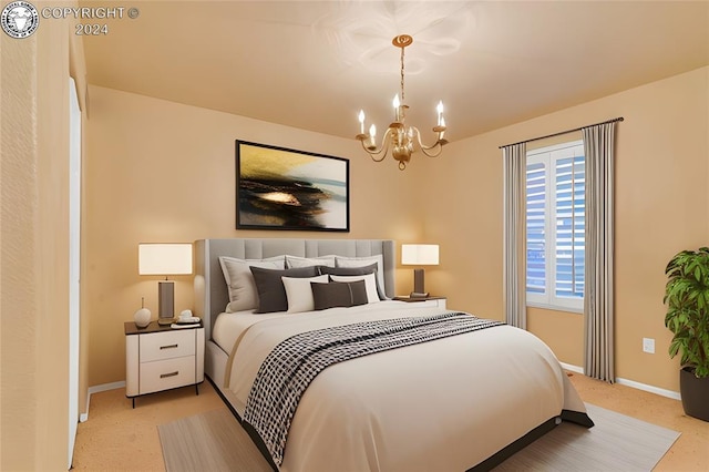 bedroom featuring an inviting chandelier and light colored carpet