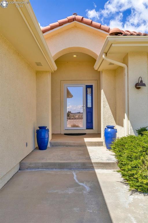 property entrance with a patio