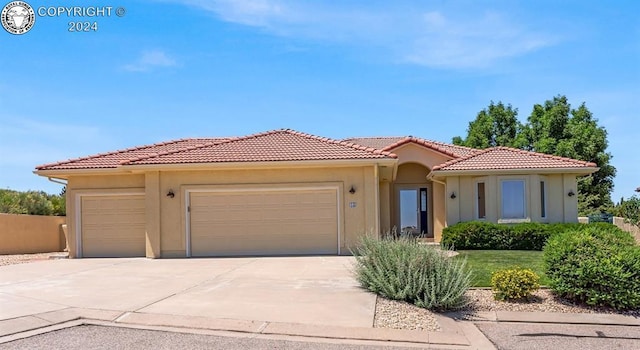 mediterranean / spanish house with a garage