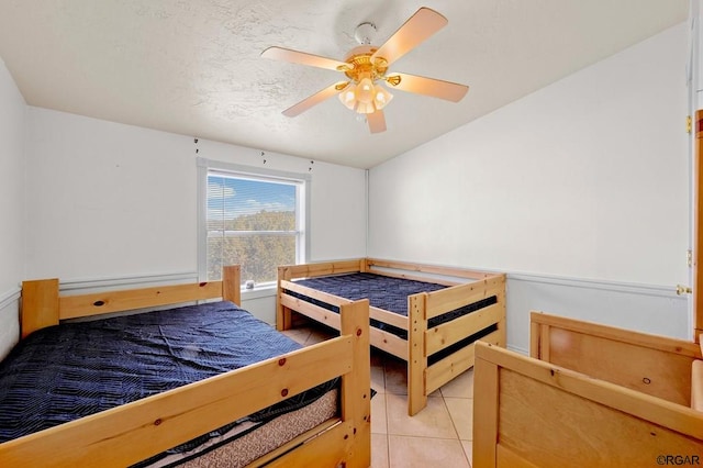 tiled bedroom with ceiling fan