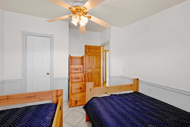 bedroom with tile patterned flooring and ceiling fan