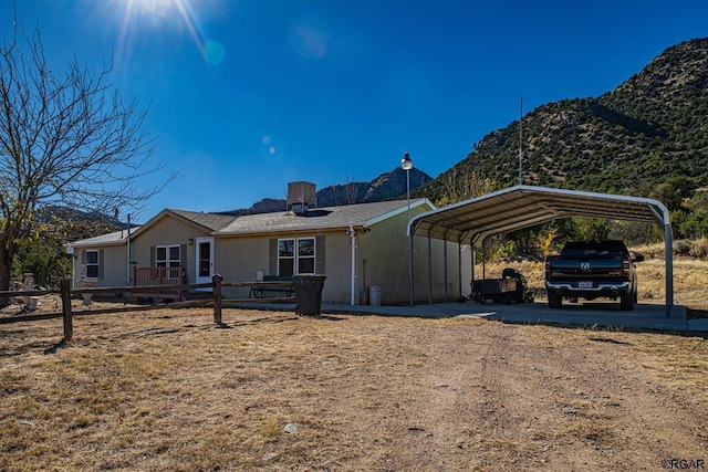 view of front of home featuring a carport and a mountain view