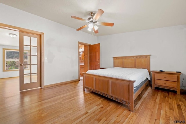 bedroom featuring ensuite bathroom, light wood-type flooring, ceiling fan, and french doors