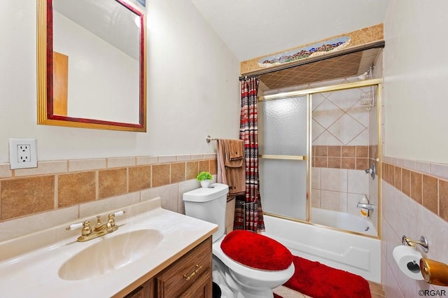 full bathroom featuring enclosed tub / shower combo, tile walls, vanity, and toilet