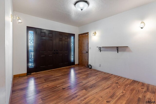 foyer entrance with dark hardwood / wood-style floors