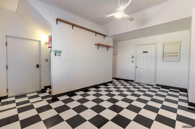 foyer with ceiling fan and lofted ceiling