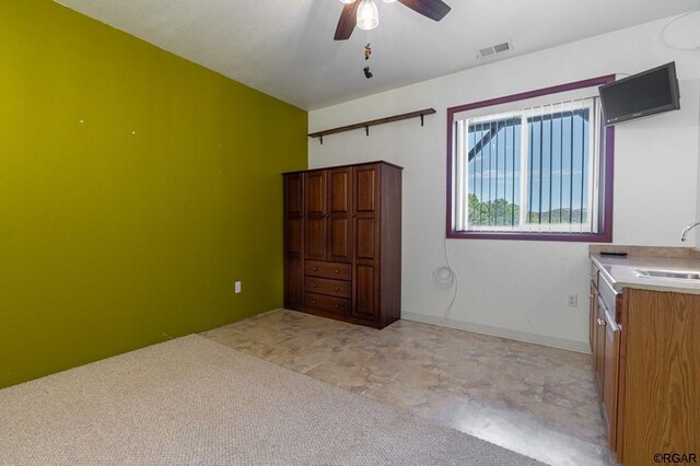 interior space with ceiling fan and sink