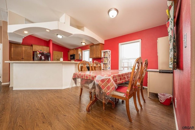 dining area with hardwood / wood-style flooring and lofted ceiling