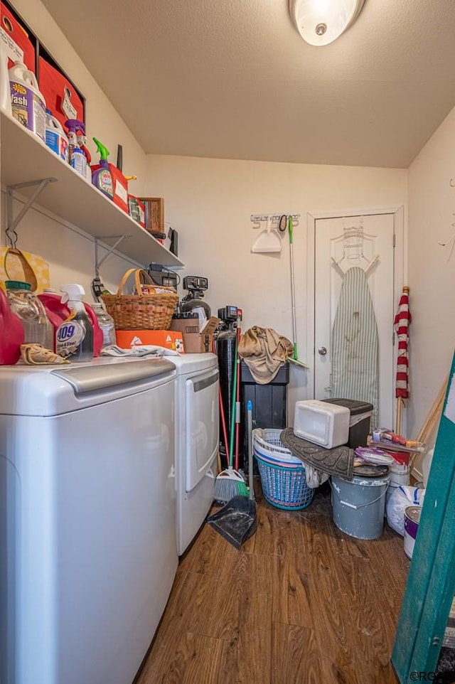 clothes washing area with hardwood / wood-style flooring and separate washer and dryer