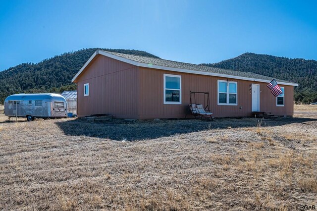 rear view of house with a mountain view