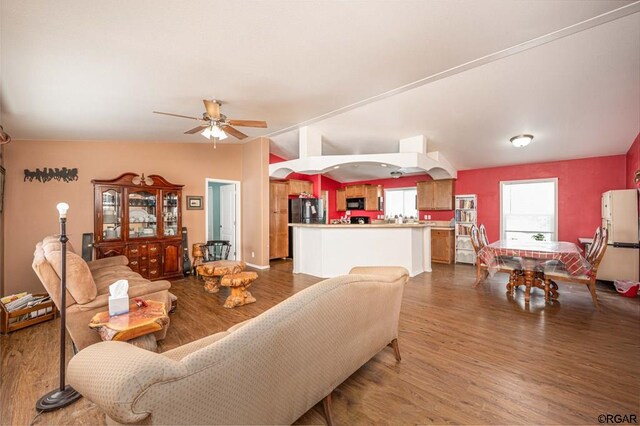 living room featuring dark hardwood / wood-style floors and ceiling fan