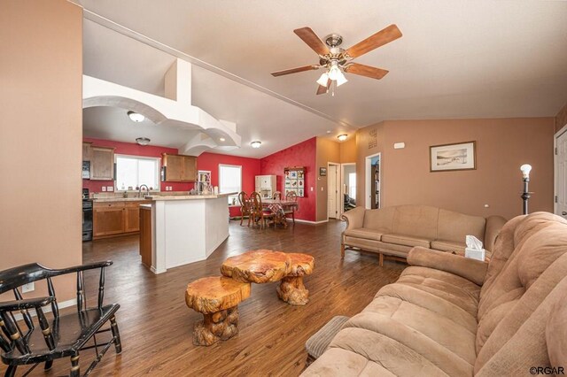 living room with vaulted ceiling, dark wood-type flooring, sink, and ceiling fan