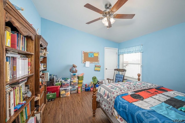 bedroom featuring hardwood / wood-style flooring, vaulted ceiling, and ceiling fan