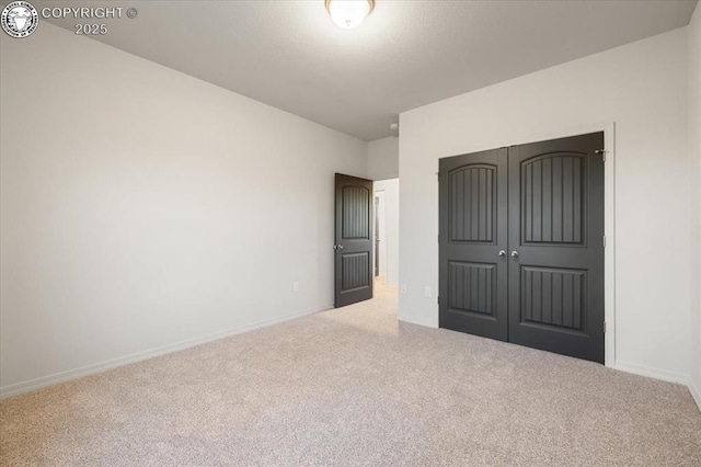 unfurnished bedroom with carpet floors and a closet