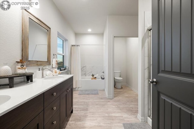 full bathroom with vanity, hardwood / wood-style floors, independent shower and bath, and toilet