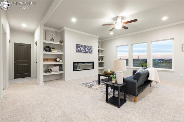 carpeted living room with ornamental molding, ceiling fan, and built in shelves