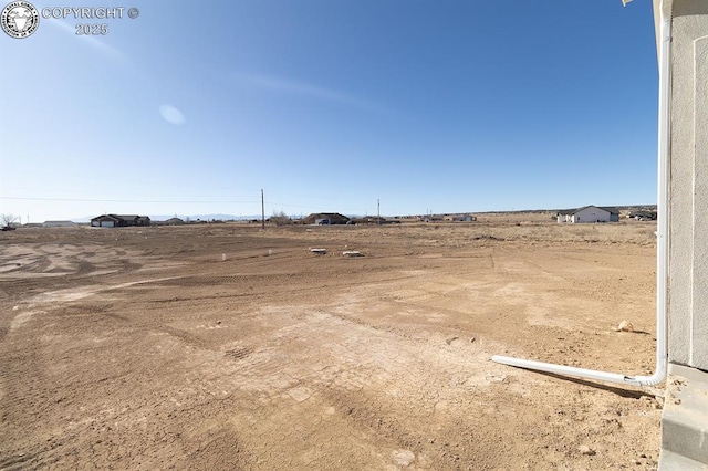 view of yard with a rural view