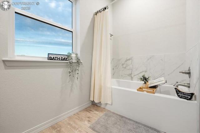 bathroom featuring a bath and wood-type flooring