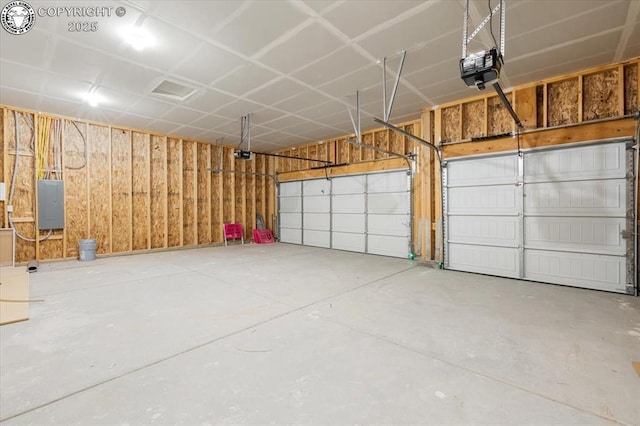 garage featuring a garage door opener and electric panel