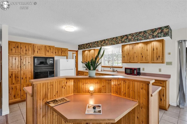 161 Shannon Rd, Cotopaxi, CO 81223 - kitchen featuring black appliances, light tile patterned floors, a textured ceiling, and light countertops