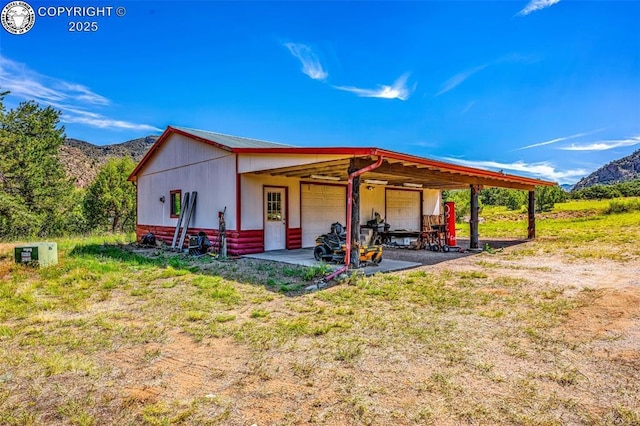161 Shannon Rd, Cotopaxi, CO 81223 - back of property with a mountain view, a garage, dirt driveway, and an outdoor structure