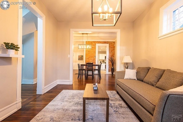121 W Evans Ave, Pueblo, CO 81004 - living room with baseboards, dark wood-style flooring, and an inviting chandelier