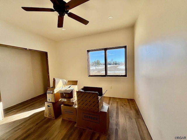 bedroom with dark hardwood / wood-style flooring and ceiling fan