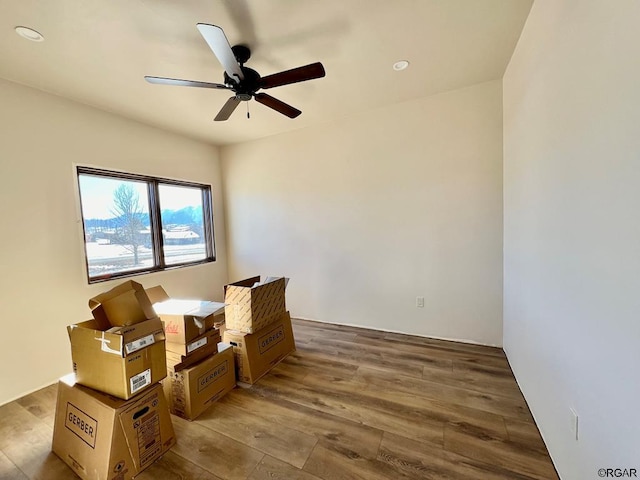 living area with hardwood / wood-style flooring and ceiling fan