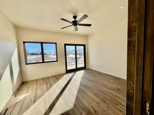 empty room featuring ceiling fan and light wood-type flooring