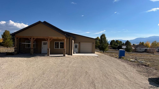 view of front of home featuring a garage and a mountain view