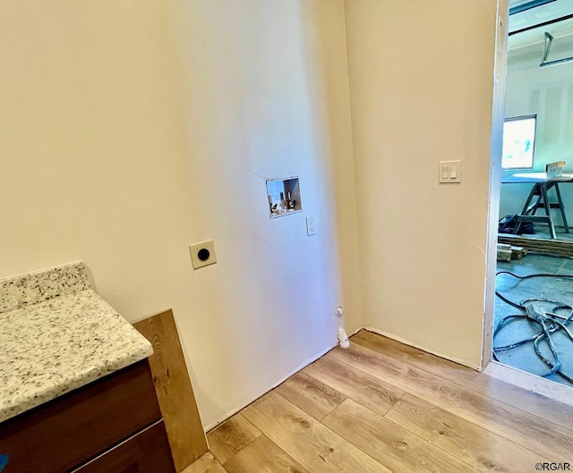 clothes washing area with washer hookup, light wood-type flooring, and electric dryer hookup