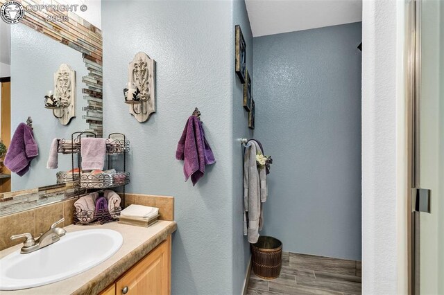 bathroom featuring vanity and backsplash