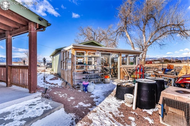 exterior space with a mountain view and central air condition unit