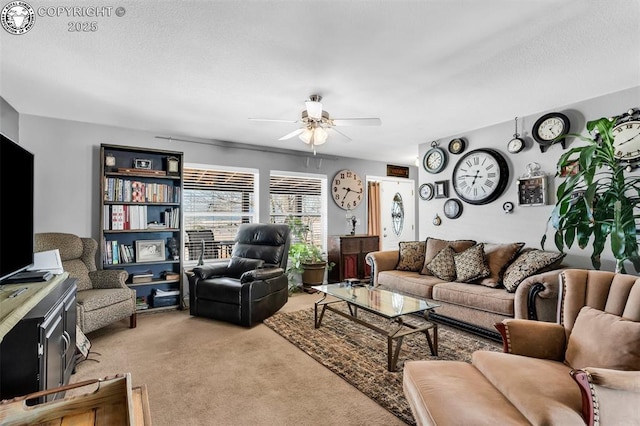 carpeted living room with ceiling fan