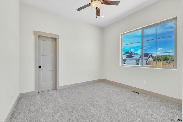 carpeted empty room with ceiling fan