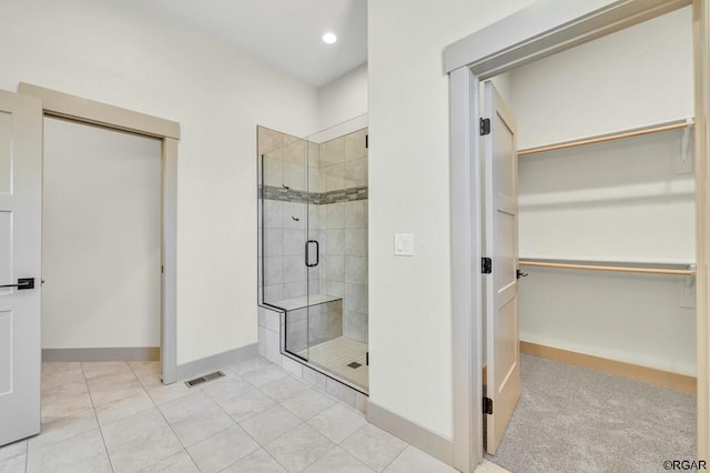 bathroom featuring tile patterned floors and walk in shower