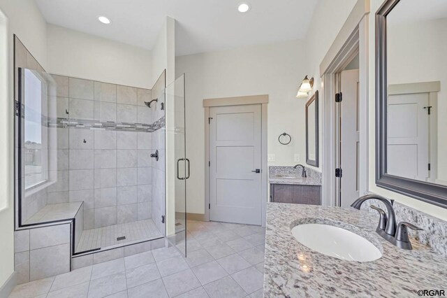 bathroom featuring vanity, tile patterned flooring, and walk in shower