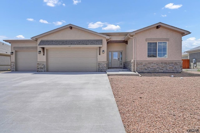 117 Rocchio Dr, Florence, CO 81226 - ranch-style home featuring concrete driveway, an attached garage, stucco siding, and stone siding