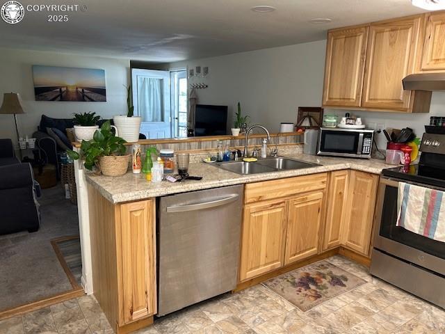 600 Raintree Blvd Unit 76, Canon City, CO 81212 - kitchen featuring stainless steel appliances, open floor plan, a peninsula, under cabinet range hood, and light brown cabinetry