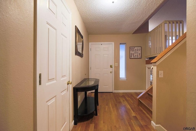 entryway featuring hardwood / wood-style floors and a textured ceiling