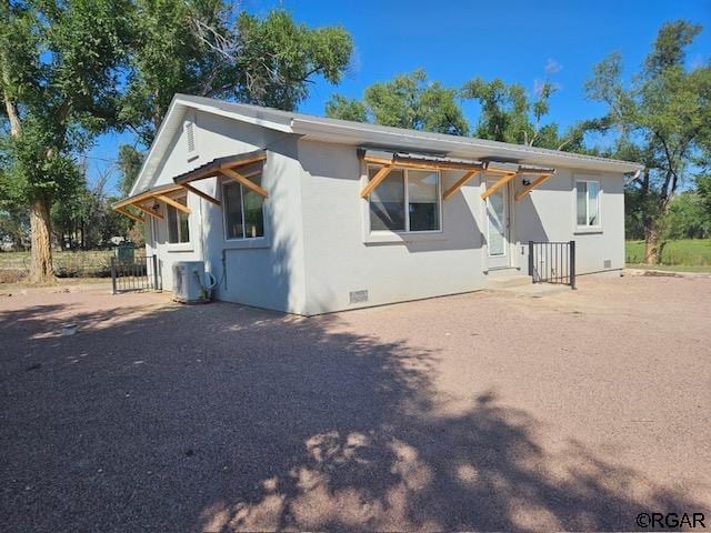 view of front of home with crawl space and stucco siding