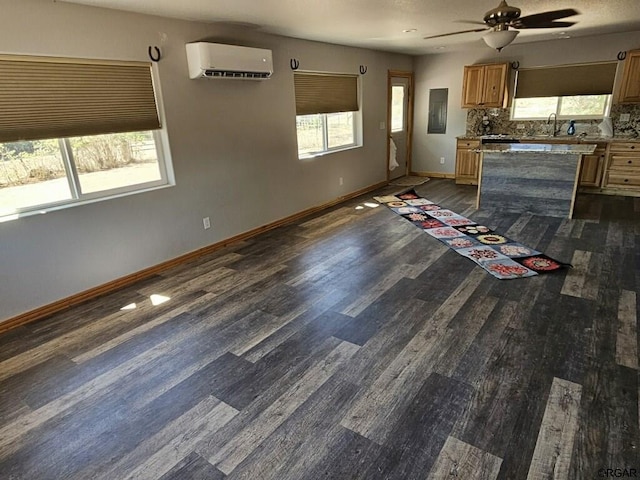 760 D St, Penrose, CO 81240 - kitchen with dark wood-style floors, backsplash, an AC wall unit, and baseboards