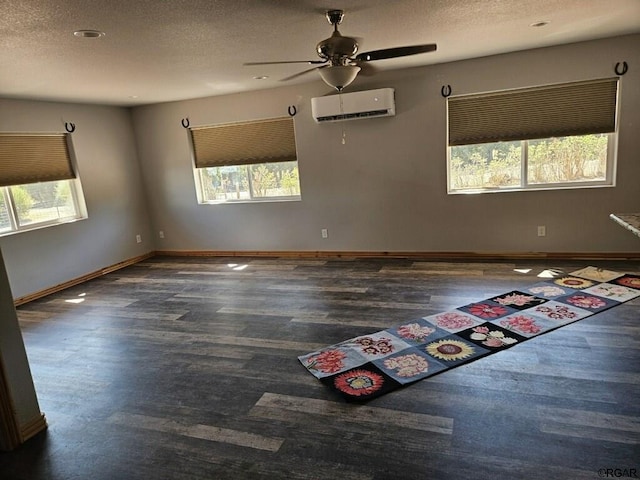 760 D St, Penrose, CO 81240 - unfurnished room with a wall mounted air conditioner, baseboards, a textured ceiling, and wood finished floors