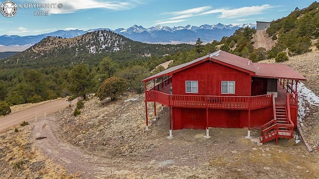 297 S Matterhorn Cir, Westcliffe, CO 81252 - exterior space with stairs, a deck with mountain view, and a view of trees