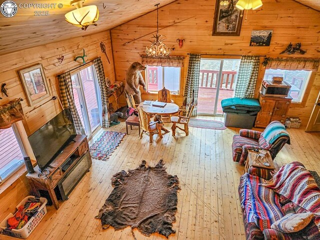 297 S Matterhorn Cir, Westcliffe, CO 81252 - living area featuring hardwood / wood-style floors, lofted ceiling, wood walls, and an inviting chandelier