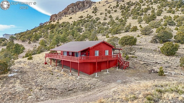 297 S Matterhorn Cir, Westcliffe, CO 81252 - back of property with a deck with mountain view and stairs