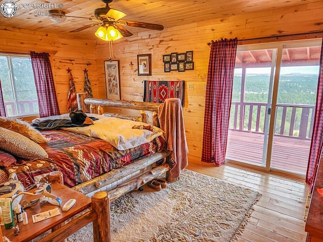 297 S Matterhorn Cir, Westcliffe, CO 81252 - bedroom with hardwood / wood-style floors, ceiling fan, wood ceiling, wood walls, and access to outside
