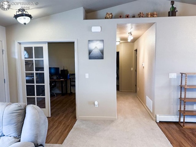 2794 Elizabeth St, Canon City, CO 81212 - living area with vaulted ceiling, a baseboard radiator, and wood finished floors