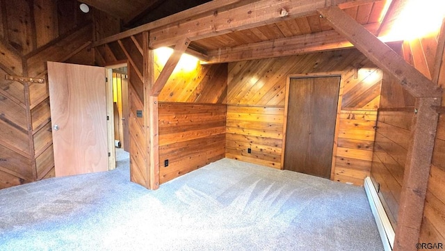 bonus room with wood walls, beamed ceiling, a baseboard radiator, carpet floors, and wood ceiling