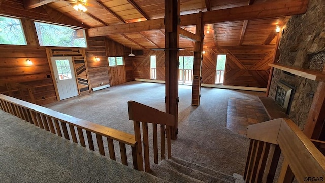 bonus room featuring wood ceiling, plenty of natural light, lofted ceiling with beams, and dark colored carpet